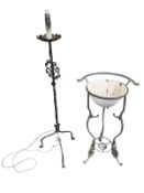 A wrought metal standard lamp and enamelled wash basin on stand