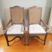 A pair of reproduction cane back carver armchairs,