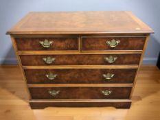 A reproduction yew wood five drawer chest,