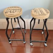 A pair of industrial metal circular stools with Hessian seats