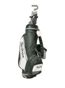 A MacGregor golf bag containing Wilson clubs,