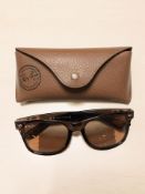 A pair of Rayban sunglasses in leather case