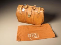 An Italian stitched tan leather case with dust cover by Bruno Conti