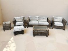 A wicker six piece conservatory suite comprising of three seater settee, pair of armchairs,