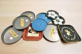 A group of tin and plastic pub serving trays including Carlsberg,