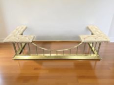 A reproduction brass and buttoned beige leather club fender,