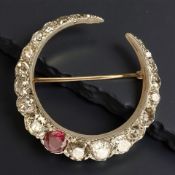A fine quality ruby and diamond crescent brooch, set with 22 diamonds, approximately 6cts,