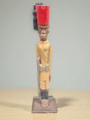 A painted wooden figure of a soldier wearing a fez, height 120 cm,
