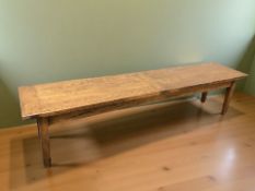 A long stained beech low bench,