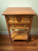 A reproduction yewwood three drawer side table,