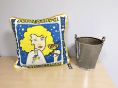 A large metal champagne bucket together with a Babycham cushion