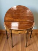 A George III inlaid mahogany demi lune turn over top table,