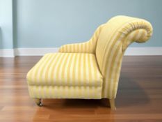 A contemporary chaise longue in striped yellow upholstery,