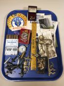 Various items including bottle openers, post cards, pack of cigars,