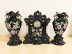 An early 20th century ceramic mantel clock garniture,