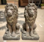 A pair of painted and weathered concrete garden lion statues,