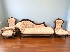A late Victorian carved walnut three piece salon suite comprising of chaise longue, length 180 cm,