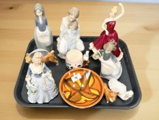 A group of china ornaments and figures including Nao, Poole dish,