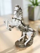 A large modern silvered figure of a rearing horse,