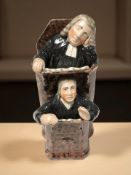 A Staffordshire Moses and The Vicar pottery figure group,