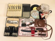A group of cutlery sets, vintage camera,
