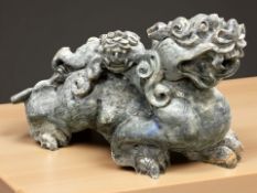A large Oriental solid carved granite statue of a dragon,