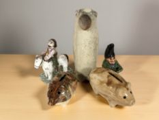 Two antique Scottish piggy banks, primitive pottery horse and rider,