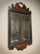 An 18th century carved mahogany mirror with original glass,