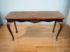 A reproduction shaped top console table on pad feet,