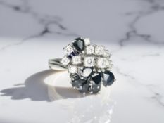 An 18ct gold sapphire and diamond ring, approximately 1.1ct, size N.