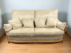 An Ercol light elm three piece lounge suite