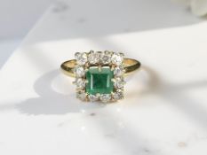An 18ct gold emerald and diamond ring, size P CONDITION REPORT: 3.