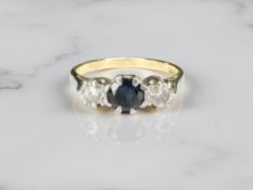 An 18ct yellow gold antique three stone diamond and sapphire ring, size K/L.