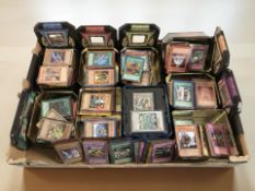 A large quantity of Yu-Gi-Oh! trading cards in tins.