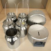 A group of stainless steel swing handled canisters.