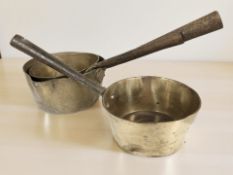 Three steel handled brass saucepans, longest 40 cm.