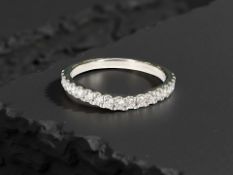 An 18ct white gold diamond half eternity ring, approximately 0.4cts, size L.