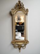 A late-19th century gilt wood and gesso girandole, with pillared supports surmounted by a cherub,