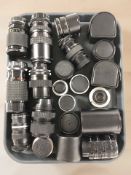 A collection of camera lenses including Vivitar, Hoya, Soligor, etc.