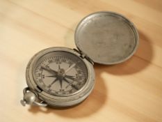 A nickel cased Wittnauer pocket compass, stamped 'US'.