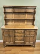 An Ercol elm dresser, 145 cm x 51 cm x 168 cm.