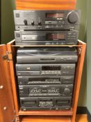 A reproduction yew wood entertainment cabinet containing Technics and Sony hi-fi separates.