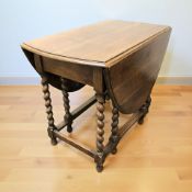 An oak barley twist gateleg drop leaf dining table, width 92 cm.