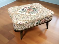 An Ercol footstool, with floral cushion, width 70 cm.