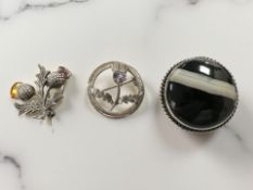 Two Scottish silver thistle brooches and a further agate example