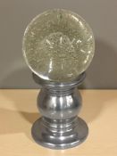 A large crystal ball with bubble inclusions on metal stand, height 30 cm.