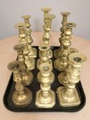 Several pairs of Victorian brass candlesticks.