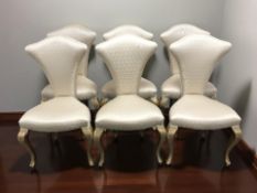 A set of six Christopher Guy dining chairs, in silvered fabric raised on gilt cabriole legs.