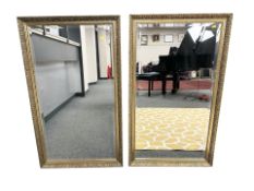 A pair of bevelled gilt framed mirrors, 69 cm x 107 cm.