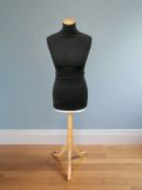 A female mannequin torso on pine stand, height 153 cm.